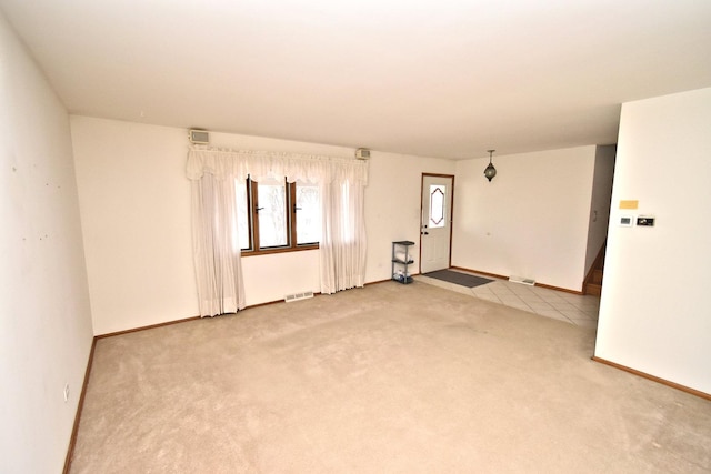 unfurnished bedroom with visible vents, two closets, baseboards, carpet floors, and a ceiling fan