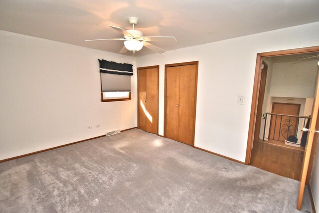 empty room featuring a wealth of natural light, visible vents, and baseboards