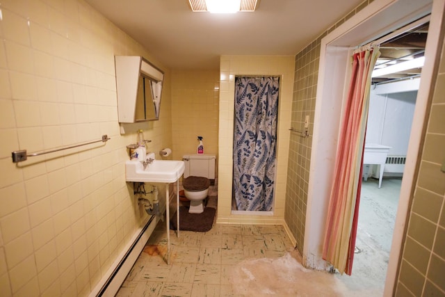 bathroom with tile patterned floors, toilet, a sink, a shower with shower curtain, and tile walls