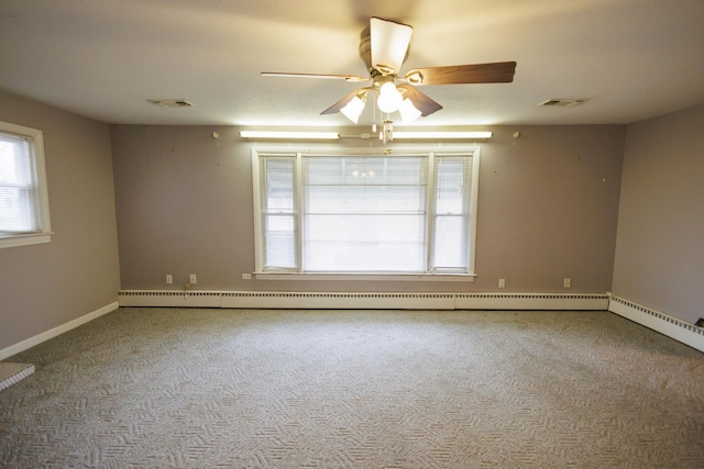 spare room featuring visible vents, baseboard heating, and carpet