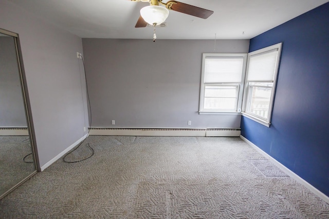 unfurnished room with a baseboard heating unit, carpet floors, baseboards, and ceiling fan