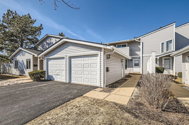 view of front facade featuring aphalt driveway and a garage