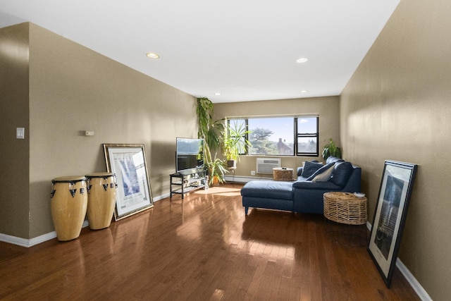 living room featuring recessed lighting, a wall mounted air conditioner, baseboards, and wood finished floors