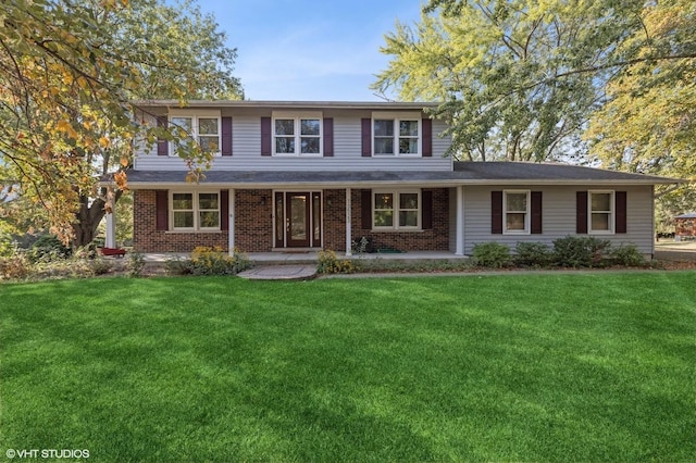 traditional-style house with a front lawn and brick siding