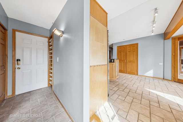 interior space featuring baseboards and track lighting