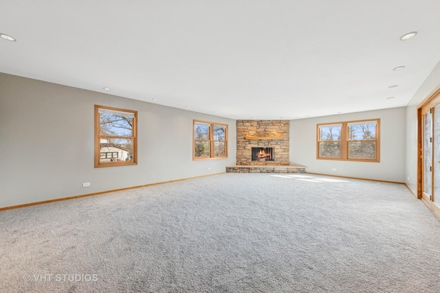 unfurnished living room featuring recessed lighting, a fireplace, and carpet floors