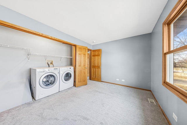 washroom featuring baseboards, visible vents, carpet floors, laundry area, and washer and dryer