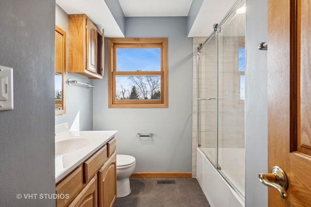 full bathroom with vanity, baseboards, visible vents, tile patterned flooring, and toilet