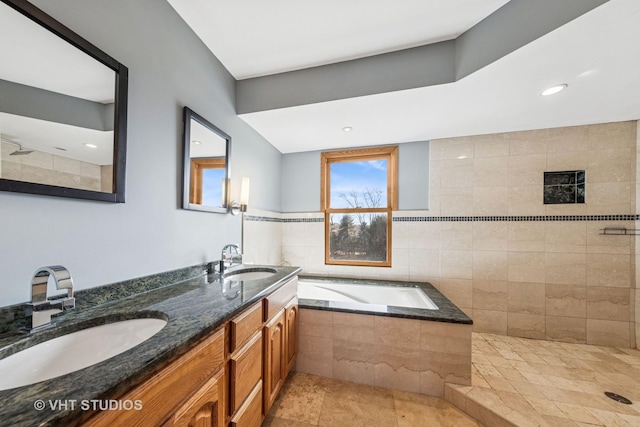 full bathroom featuring a garden tub, double vanity, a tile shower, and a sink