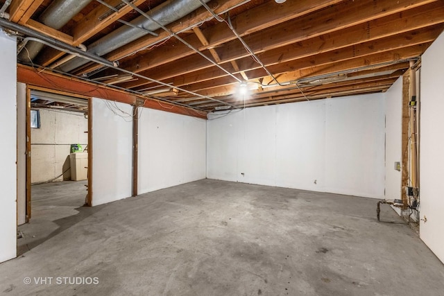 unfinished basement with washer / clothes dryer