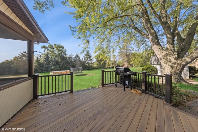 wooden terrace with a yard and grilling area