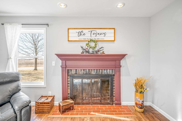 interior details featuring a fireplace, recessed lighting, wood finished floors, and baseboards