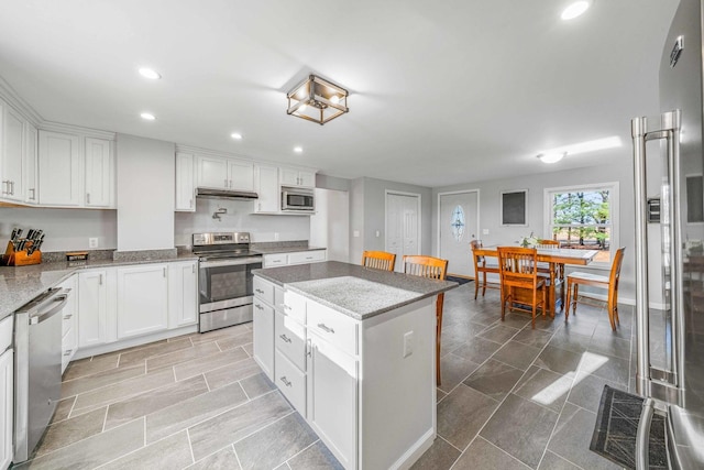 kitchen featuring under cabinet range hood, appliances with stainless steel finishes, recessed lighting, and white cabinetry