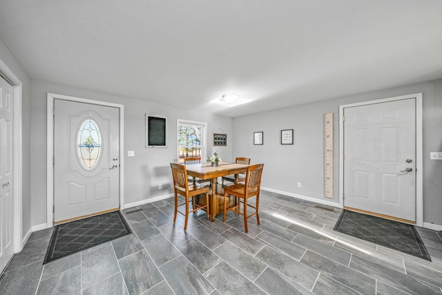 entryway featuring a healthy amount of sunlight and baseboards