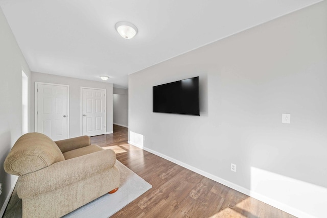 living room featuring baseboards and wood finished floors