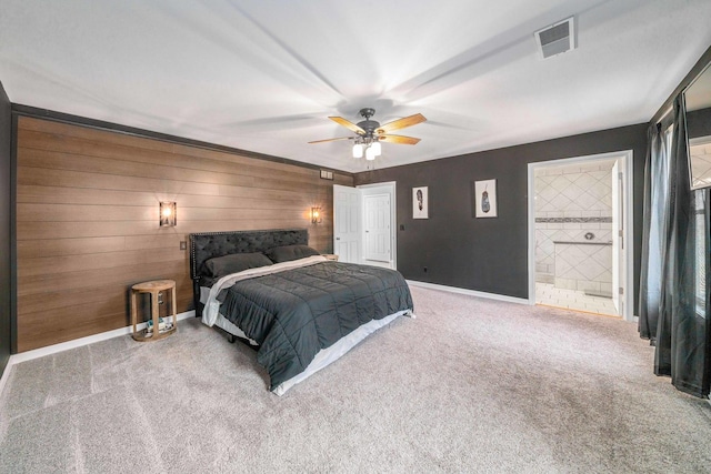 bedroom featuring a ceiling fan, visible vents, carpet floors, baseboards, and connected bathroom