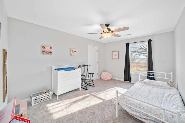 carpeted bedroom with visible vents, ceiling fan, and baseboards