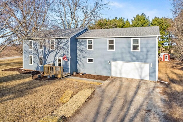 view of front of house featuring a wooden deck, a garage, dirt driveway, and a chimney