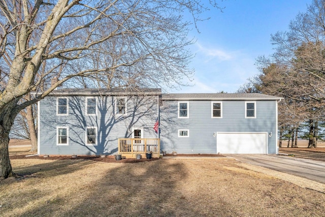 back of house featuring a garage and driveway