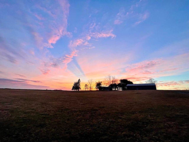 nature at dusk featuring a rural view