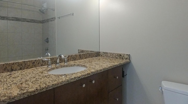 bathroom featuring toilet and vanity