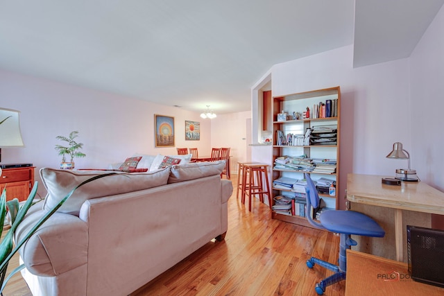 living area with a chandelier and light wood-style flooring