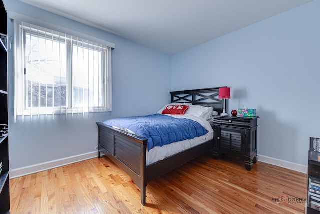 bedroom featuring light wood-type flooring and baseboards