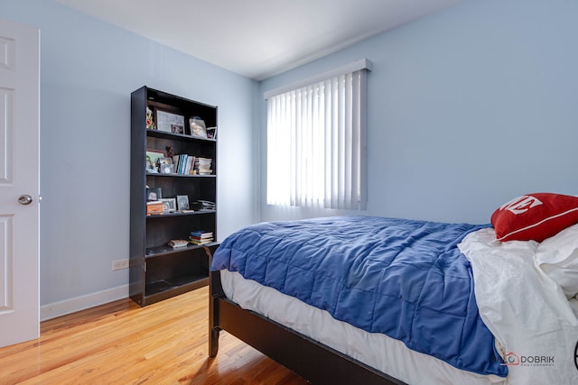 bedroom with baseboards and light wood-style floors