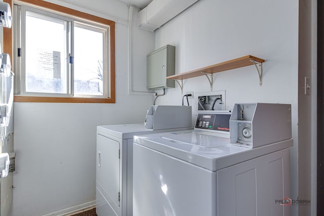 clothes washing area featuring washer and clothes dryer and laundry area