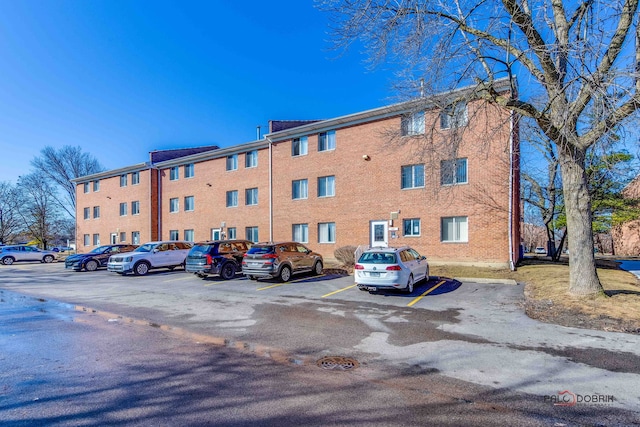 view of property featuring uncovered parking