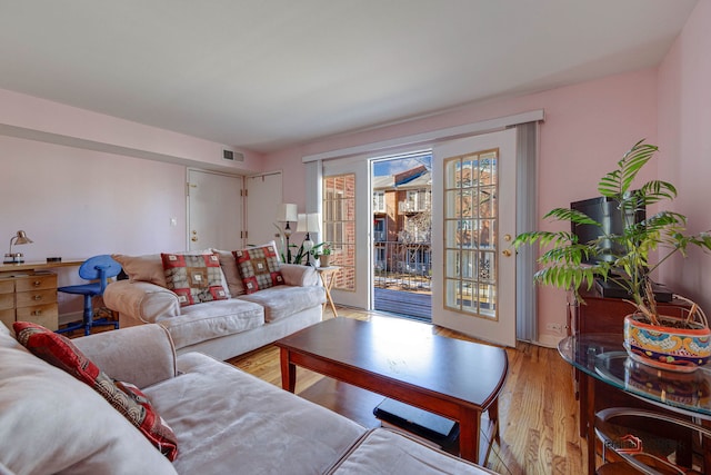 living area featuring visible vents and light wood-type flooring