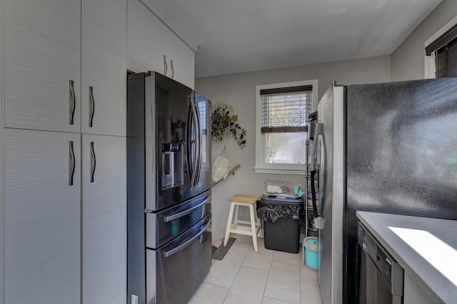 kitchen with light countertops, light tile patterned floors, and appliances with stainless steel finishes