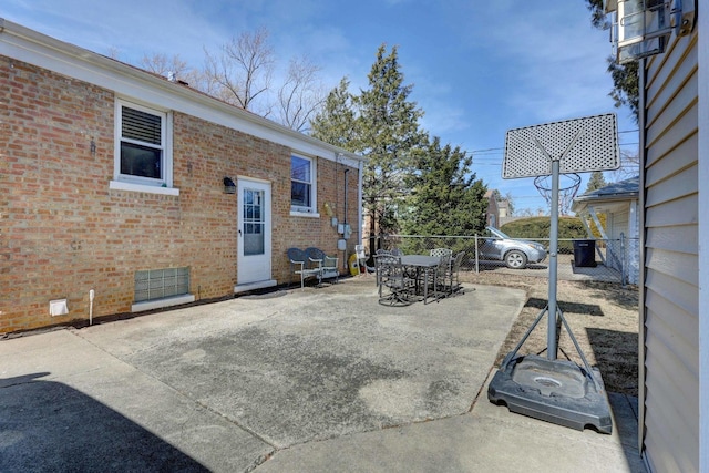 view of patio with outdoor dining area and fence