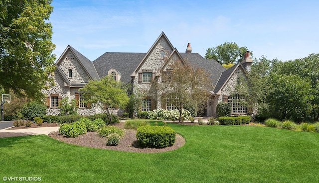 view of front facade with a front lawn and stone siding