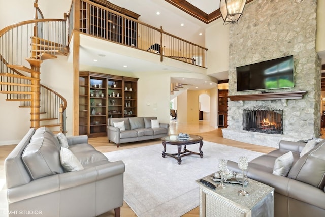 living area with stairway, a fireplace, a high ceiling, and wood finished floors