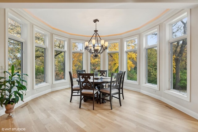 sunroom / solarium with visible vents and a notable chandelier