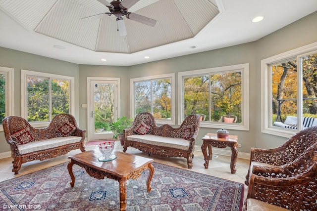 sunroom / solarium featuring plenty of natural light and ceiling fan