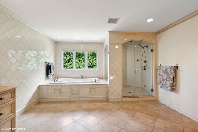 bathroom with visible vents, a shower stall, crown molding, a bath, and tile patterned flooring