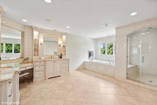 bathroom featuring visible vents, a shower stall, a bath, tile patterned floors, and tile walls