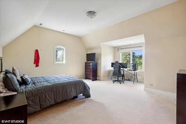 carpeted bedroom with lofted ceiling, baseboards, and visible vents