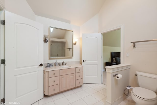 bathroom featuring tile patterned flooring, toilet, vanity, and lofted ceiling