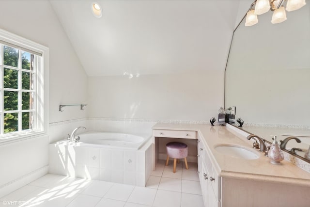 bathroom with tile patterned flooring, vaulted ceiling, vanity, and a wealth of natural light