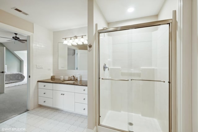 ensuite bathroom with tile patterned floors, visible vents, and a shower stall