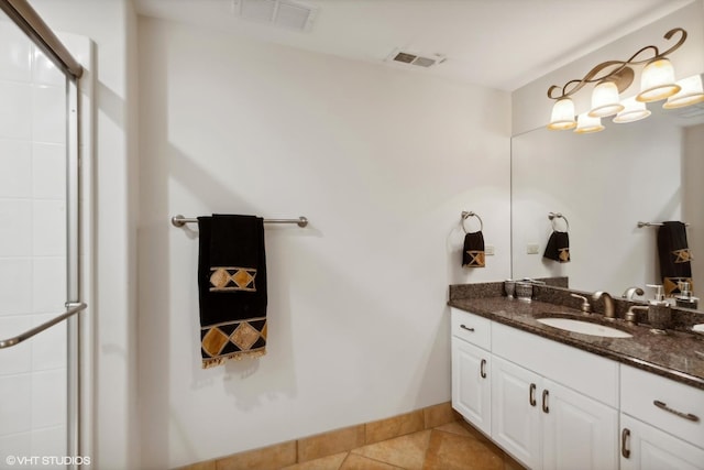 bathroom featuring vanity, tile patterned floors, visible vents, and a shower with door