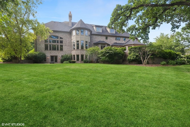 back of house with a lawn