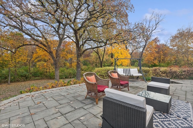 view of patio with area for grilling and a wooded view