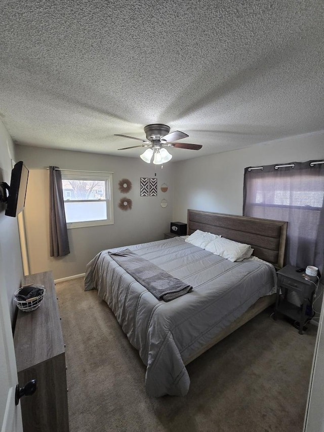 bedroom with a ceiling fan, carpet floors, and a textured ceiling