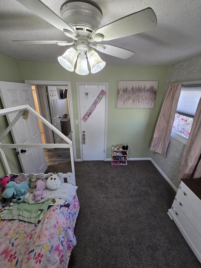 carpeted bedroom with baseboards, a textured ceiling, and a ceiling fan