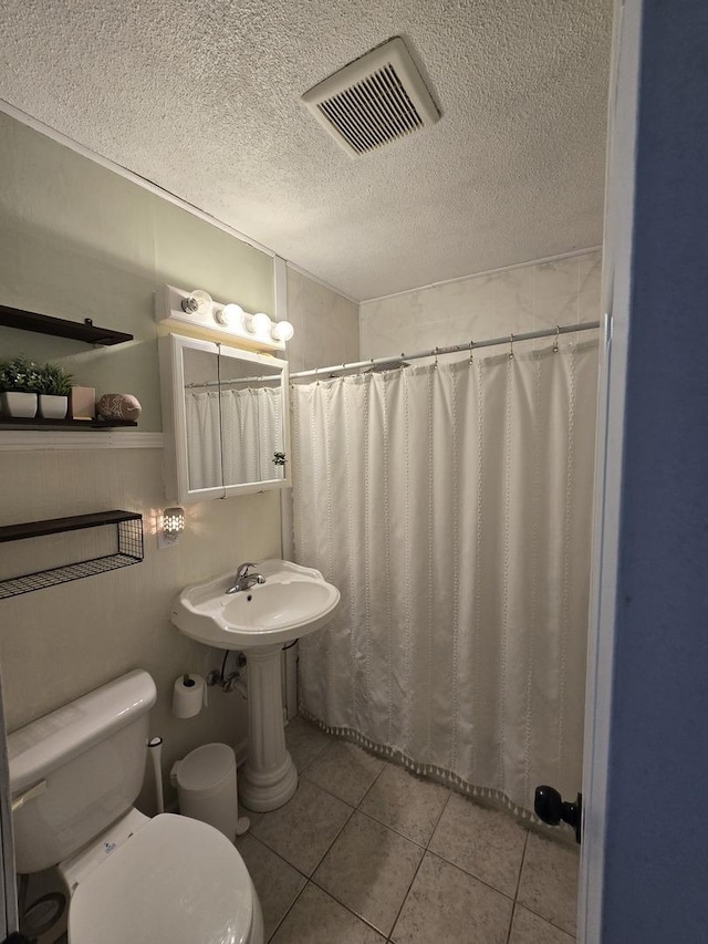 full bathroom featuring visible vents, tile patterned flooring, a textured ceiling, curtained shower, and toilet