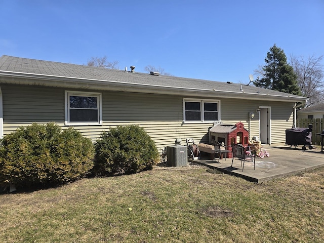 back of property featuring central air condition unit, a patio, and a yard